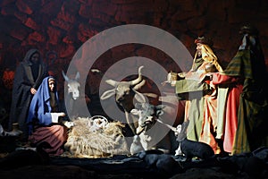Christmas nativity scene with three Wise Men presenting gifts to baby Jesus, Mary & Joseph