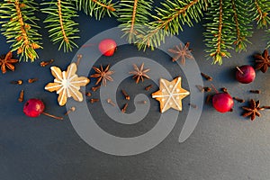 Christmas natural decoration background. Fir tree branches, cookies, spices