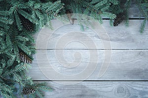 Christmas natural firbranch with cones on old wooden rustic background with copy space for text