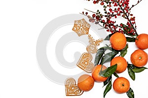 Christmas and new year atmoshpere flatlay. Overhead view. Gingerbread cookies, tangerines and branch with red berries isolated on