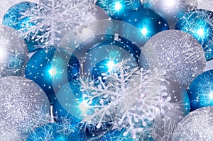 Christmas and New Year background. blue and silver sparkling balls, snowflake ornaments