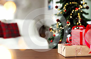 Christmas, New Year background. Empty wooden tabletop with bokeh fir tree, gift