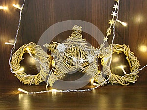 Christmas and New year background with empty dark wooden deck table over christmas tree and blurred light