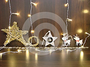 Christmas and New year background with empty dark wooden deck table over christmas tree and blurred light