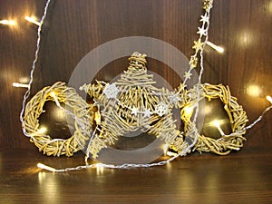 Christmas and New year background with empty dark wooden deck table over christmas tree and blurred light