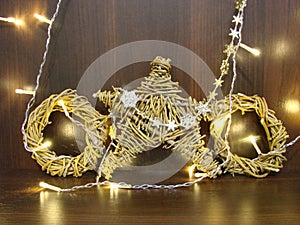 Christmas and New year background with empty dark wooden deck table over christmas tree and blurred light