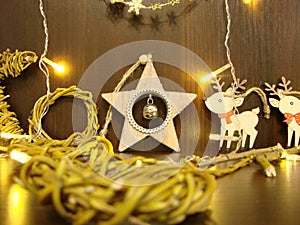 Christmas and New year background with empty dark wooden deck table over christmas tree and blurred light