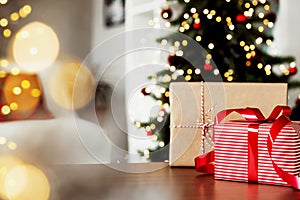 Christmas, New Year background. Empty wooden tabletop with bokeh fir tree, gift