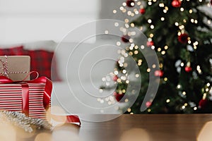 Christmas, New Year background. Empty wooden tabletop with bokeh fir tree, gift