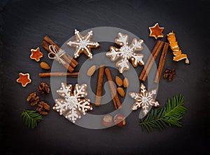 Christmas or New Year background of Gingerbread cookies, spices, nuts with sugar and snowflakes. Top view.