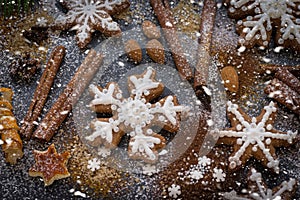 Christmas or New Year background of Gingerbread cookies, spices, nuts with sugar and snowflakes. Top view.