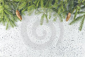 Christmas or New Year background with green fir branches and cones. Winter concept, top view, copy space