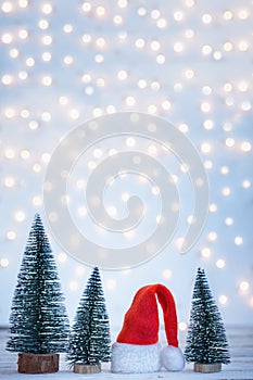 Christmas and New year background with Santa Claus hatand christmas trees. Holiday greeting card