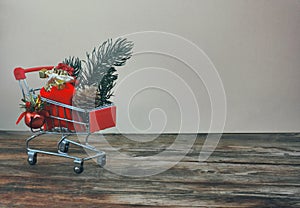 Christmas, new year background, supermarket trolley, red bag with gift