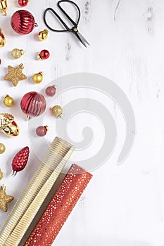 Christmas, new year background - Wrapping paper, scissors and christmas red and gold deco baubles gifts