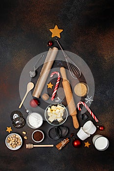 Christmas or New Year baking background. Abstract christmas tree made from baking tools and food ingredients for baking.