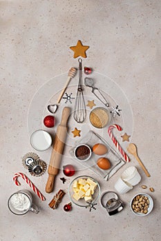 Christmas or New Year baking background. Abstract christmas tree made from baking tools and food ingredients for baking.