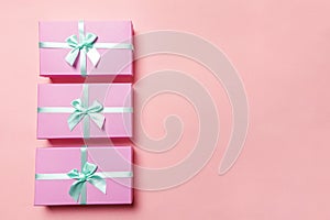 Christmas New Year birthday valentine celebration present romantic concept. Three pink gift boxex isolated on pink background