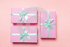 Christmas New Year birthday valentine celebration present romantic concept. Three pink gift boxex isolated on pink background