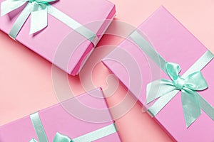 Christmas New Year birthday valentine celebration present romantic concept. Three pink gift boxex isolated on pink background