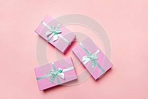 Christmas New Year birthday valentine celebration present romantic concept. Three pink gift boxex isolated on pink background