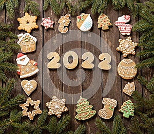 Christmas and New Year biscuit ginger cookies in festive winter shapes with glazed icing sugar decoration on wooden background