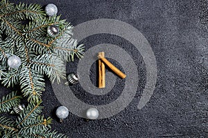 Christmas, New Year black stylish background and frame with fir branch and balls. View from above. Copy space, new year clock