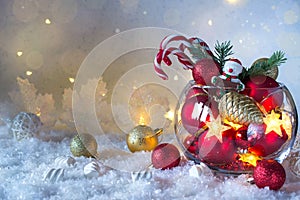 Christmas or New year bright decoration in glass vase with candy canes on snow background. Greeting card