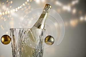 Christmas and New Year celebration with champagne bottle in crystal bucket. Holiday dinner table setting