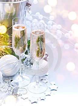 Christmas and New Year celebration with champagne. Holiday dinner table setting with Christmas tree decoration