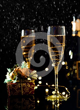 Christmas and New Year celebration with champagne. New Year holiday decorated table. Two Champagne Glasses, vintage toned