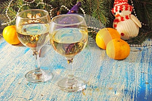 Christmas and New Year celebration with champagne. New Year holiday decorated table. Two Champagne Glasses, vintage toned