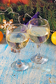 Christmas and New Year celebration with champagne. New Year holiday decorated table. Two Champagne Glasses, vintage toned