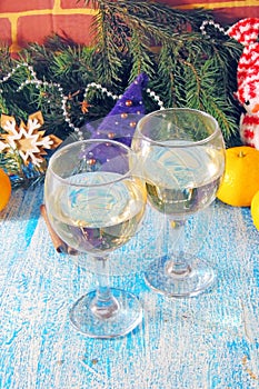 Christmas and New Year celebration with champagne. New Year holiday decorated table. Two Champagne Glasses, vintage toned