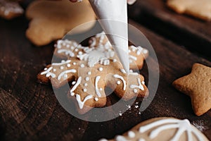 Decorating gingerbread cookie with sugar icing photo