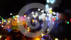 Christmas New Year Composition with candle, garlands, colorful lights, selective focus Black Background Holiday Decoration, copy