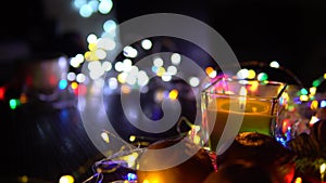 Christmas New Year Composition with candle, garlands, colorful lights, selective focus Black Background Holiday Decoration, copy