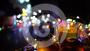 Christmas New Year Composition with candle, garlands, colorful lights, selective focus Black Background Holiday Decoration, copy