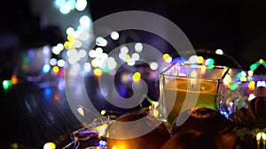 Christmas New Year Composition with candle, garlands, colorful lights, selective focus Black Background Holiday Decoration, copy