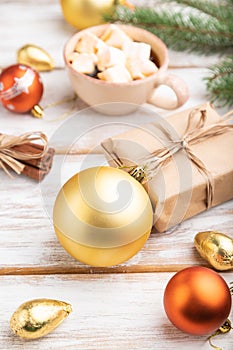 Christmas or New Year composition. Decorations, box, balls, fir and spruce branches, cup of coffee, on a white wooden background.