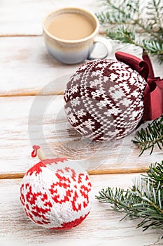 Christmas or New Year composition. Decorations, knitted balls, fir and spruce branches, on a white wooden background. Side view,