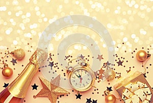 Christmas or New Year composition, frame, pink background with gold Christmas decorations, stars, snowflakes, balls, alarm clock,