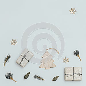 Christmas or New Year composition. Christmas gift boxes, pine cones, spruce branches, wooden toys. Top view.