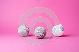 Christmas New Year composition. Gifts, silver and white ball decorations on pink background. Winter holidays concept