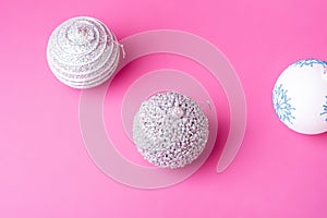 Christmas New Year composition. Gifts, silver and white ball decorations on pink background. Winter holidays concept