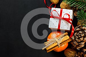 Christmas New Year Composition Greeting Card. Tangerine Cinnamon Sticks Pine Cones Fir Tree branches Gift Box