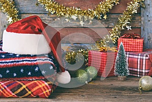 Christmas and New Year composition. Plaid, Santa Claus hat, gifts, xmas tree decorations on wooden background. Winter Holiday