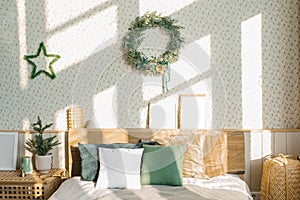 Christmas and New Year composition. A Scandinavian bedroom with light bed linen and bright pillows, Christmas decorations with