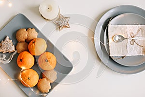 Christmas and New Year composition. tangerines, ginger cookies. festive table setting. Flat lay,  holiday background.