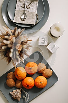 Christmas and New Year composition. tangerines, ginger cookies. festive table setting. Flat lay,  holiday background.